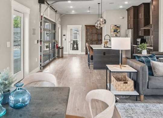 A modern living room with a grey couch and a wooden coffee table.