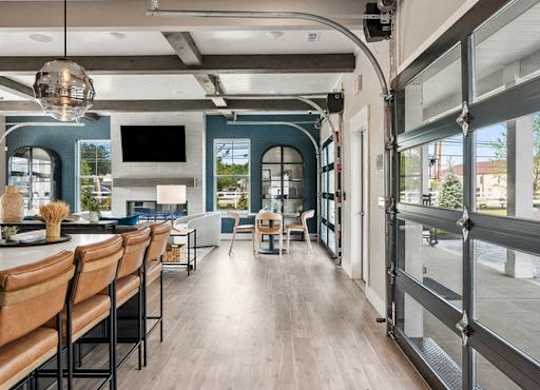 A modern interior with a long wooden table and chairs.