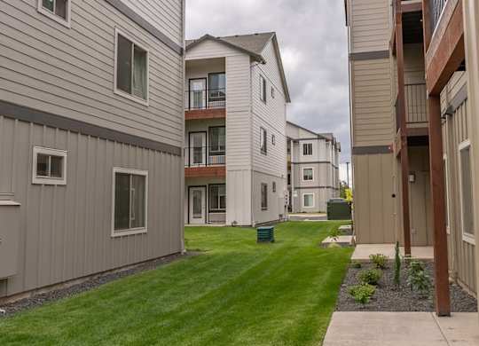 A grassy area in front of apartment buildings at Marcola Apartment Homes, Forest Grove