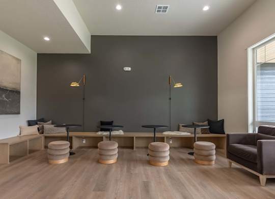 A living room with a grey wall and a brown couch at Marcola Apartment Homes, Oregon