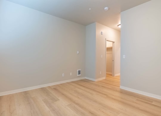 A room with wooden flooring and white walls at Marcola Apartment Homes, Forest Grove, OR