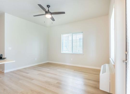 A room with a ceiling fan and a window at Marcola Apartment Homes, Oregon