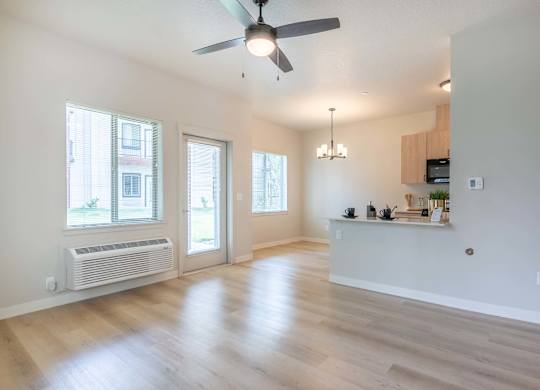A spacious room with a ceiling fan and wooden flooring at Marcola Apartment Homes, Forest Grove, OR