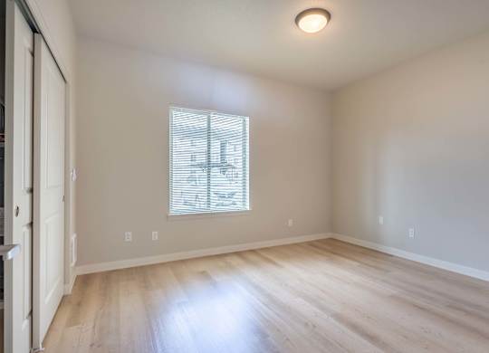 A room with a window and wooden flooring at Marcola Apartment Homes, Oregon, 97477