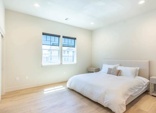 A bedroom with a large bed and a window at Westgate Apartment Homes, Oregon