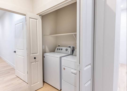 A white laundry room with a washer and dryer at Westgate Apartment Homes, Pendleton, 97801