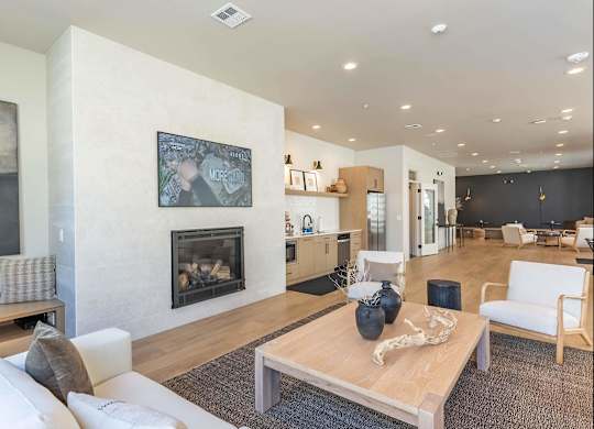 A living room with a fireplace and a painting on the wall at Westgate Apartment Homes, Pendleton, OR