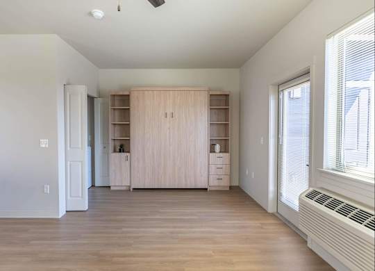A room with a wooden floor and a window on the right side at Westgate Apartment Homes, Pendleton