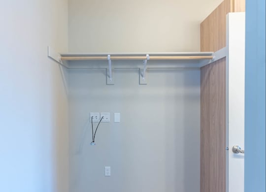 A white wall with a shelf and electrical outlets at Westgate Apartment Homes, Pendleton, 97801