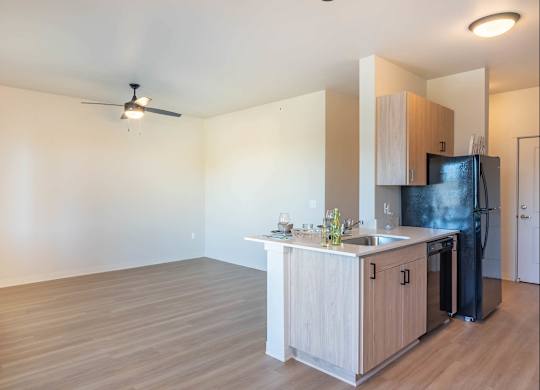 A kitchen with a black fridge and a wooden counter at Westgate Apartment Homes, Oregon