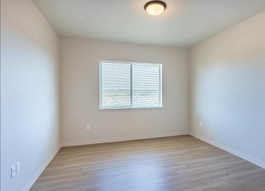 A room with a window and wooden flooring at Westgate Apartment Homes, Pendleton, 97801