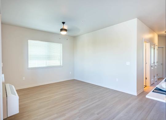 A room with a window and a heater on the wall at Westgate Apartment Homes, Oregon