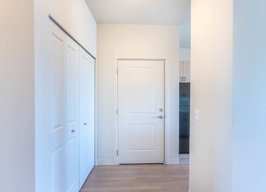 A white door is in the middle of a hallway at Westgate Apartment Homes, Pendleton, OR, 97801