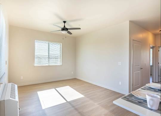 A room with a ceiling fan and a window at Westgate Apartment Homes, Oregon