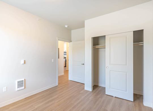 A white room with a door and a window at Westgate Apartment Homes, Pendleton, Oregon