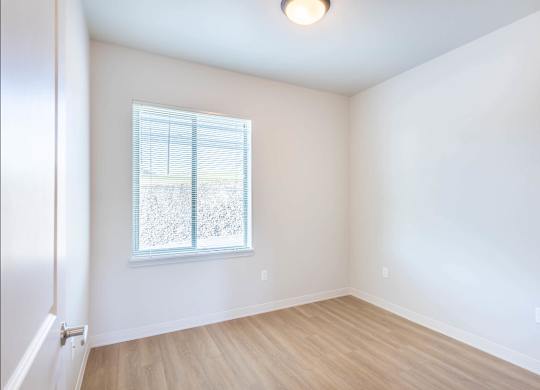A room with a window and wooden flooring at Westgate Apartment Homes, Oregon, 97801