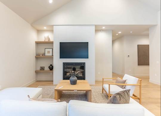 A modern living room with a fireplace and a flat screen TV at Westgate Apartment Homes, Pendleton, 97801