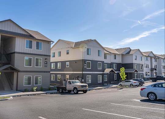 A row of modern townhouses with cars parked in front at Westgate Apartment Homes, Pendleton, Oregon