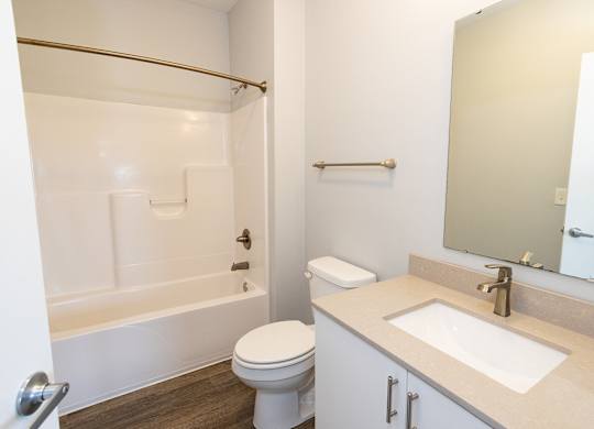 A white toilet sits next to a sink in a bathroom.