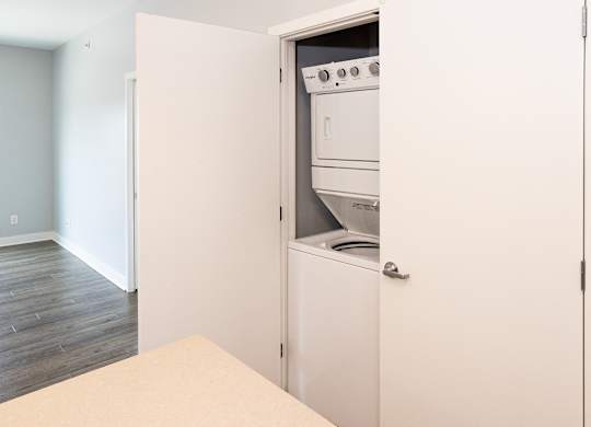 A white oven is built into a wall in a kitchen.