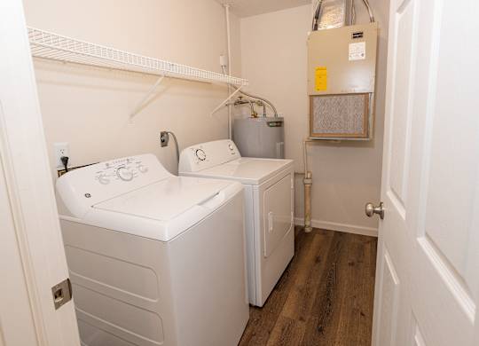 A small laundry room with a washer and dryer.