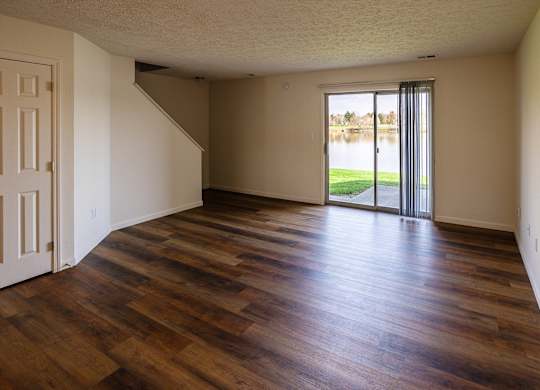 A room with wooden floors and a white door.