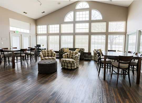 A large room with wooden floors and a large window.