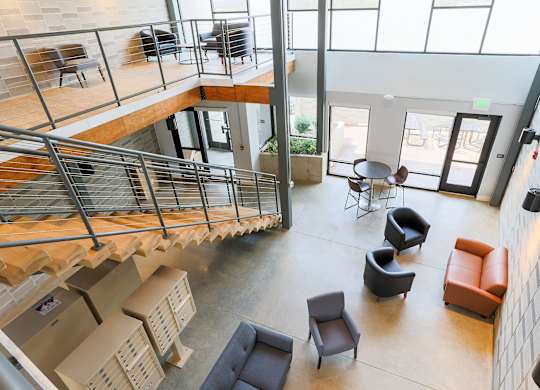 A modern interior with a spiral staircase and seating area.