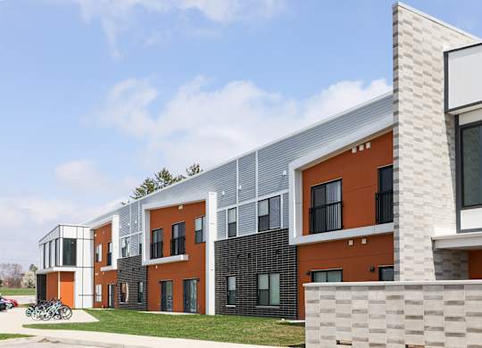 A modern building with orange and grey exterior.