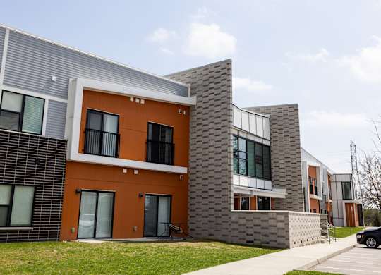 A modern building with orange and grey exterior.