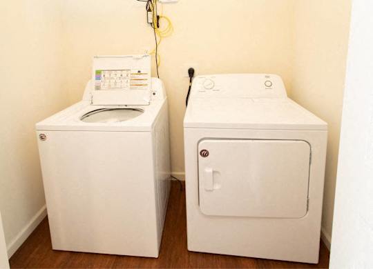 A washing machine and dryer in a small room.