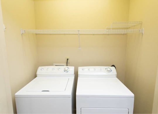 A small laundry room with a washer and dryer.