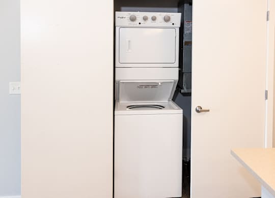 A white dishwasher and oven in a kitchen.