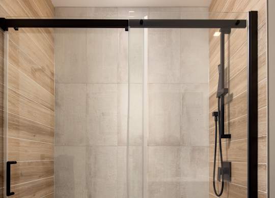 A modern bathroom with a walk-in shower.at Damask, Ontario