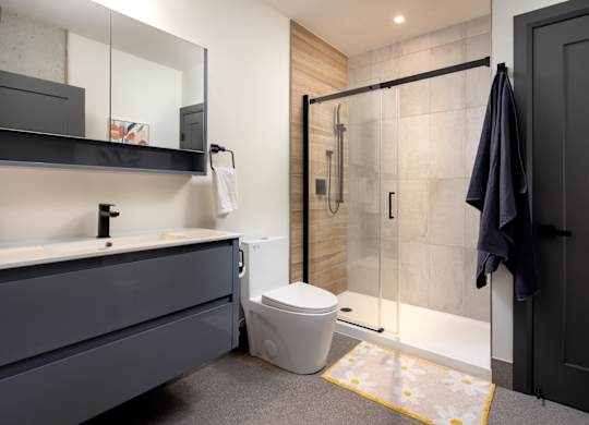Modern bathroom featuring walk-in shower and floating vanity at Damask, Windsor Ontario