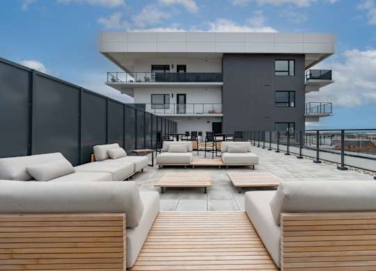 A modern building with a balcony and seating area at Damask, Ontario, N8S 0B7