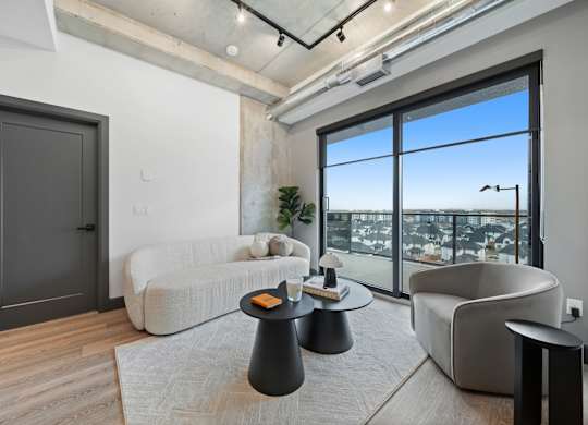 A modern living room with a large window overlooking the city