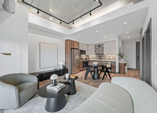 A modern living room with a grey sofa and a black coffee table