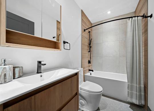 A modern bathroom with a white sink and a white toilet at Damask, Windsor