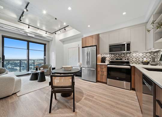 A modern kitchen with a dining table and chairs at Damask, Ontario