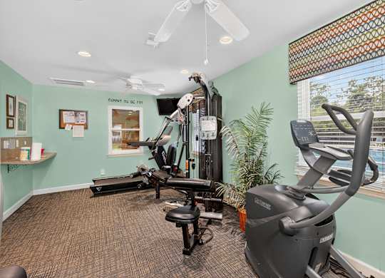 A room with a treadmill, exercise bike, and other equipment at Sawbranch Apartments, Summerville, South Carolina