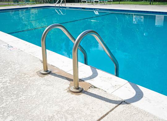 A pool with a metal ladder at Sawbranch Apartments, South Carolina