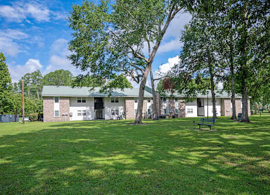 A green lawn in front of a building. at Sawbranch Apartments, South Carolina, 29485