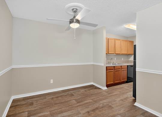 A room with a ceiling fan and wooden flooring at Sawbranch Apartments, Summerville, South Carolina