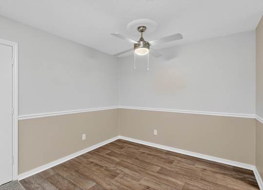 A room with a ceiling fan and light fixture at Sawbranch Apartments, Summerville 29485