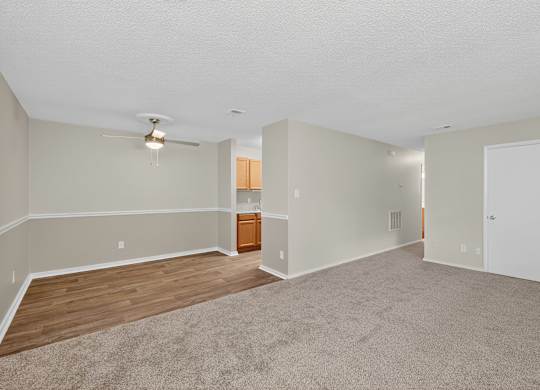 A spacious room with a ceiling fan and lighting fixture at Sawbranch Apartments, Summerville, SC, 29485