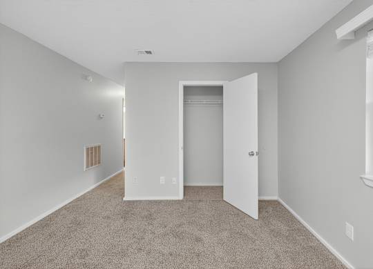 A room with a carpeted floor and a doorway leading to another room at Sawbranch Apartments, Summerville