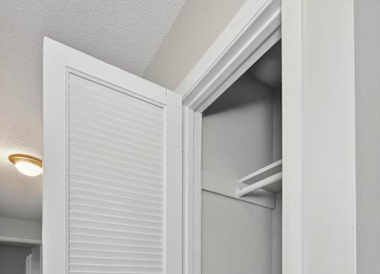 A white door with a silver handle is open at Sawbranch Apartments, Summerville, South Carolina