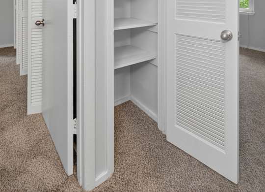 A row of white pantry doors are open at Sawbranch Apartments, South Carolina