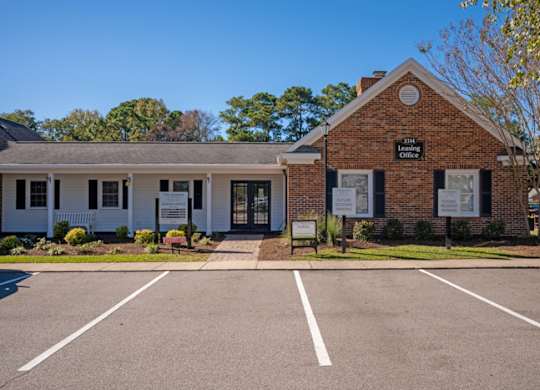 A small brick building with a sign  at The Preserve at Pine Valley Apartments, North Carolina, 28412